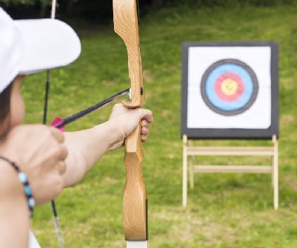 A man taking aim to shoot his soft archery arrow - Kaldan Samudra Palace